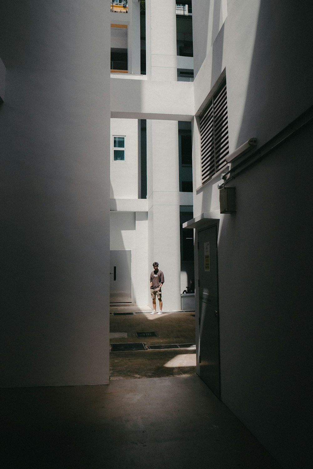 a man standing in a doorway between two buildings