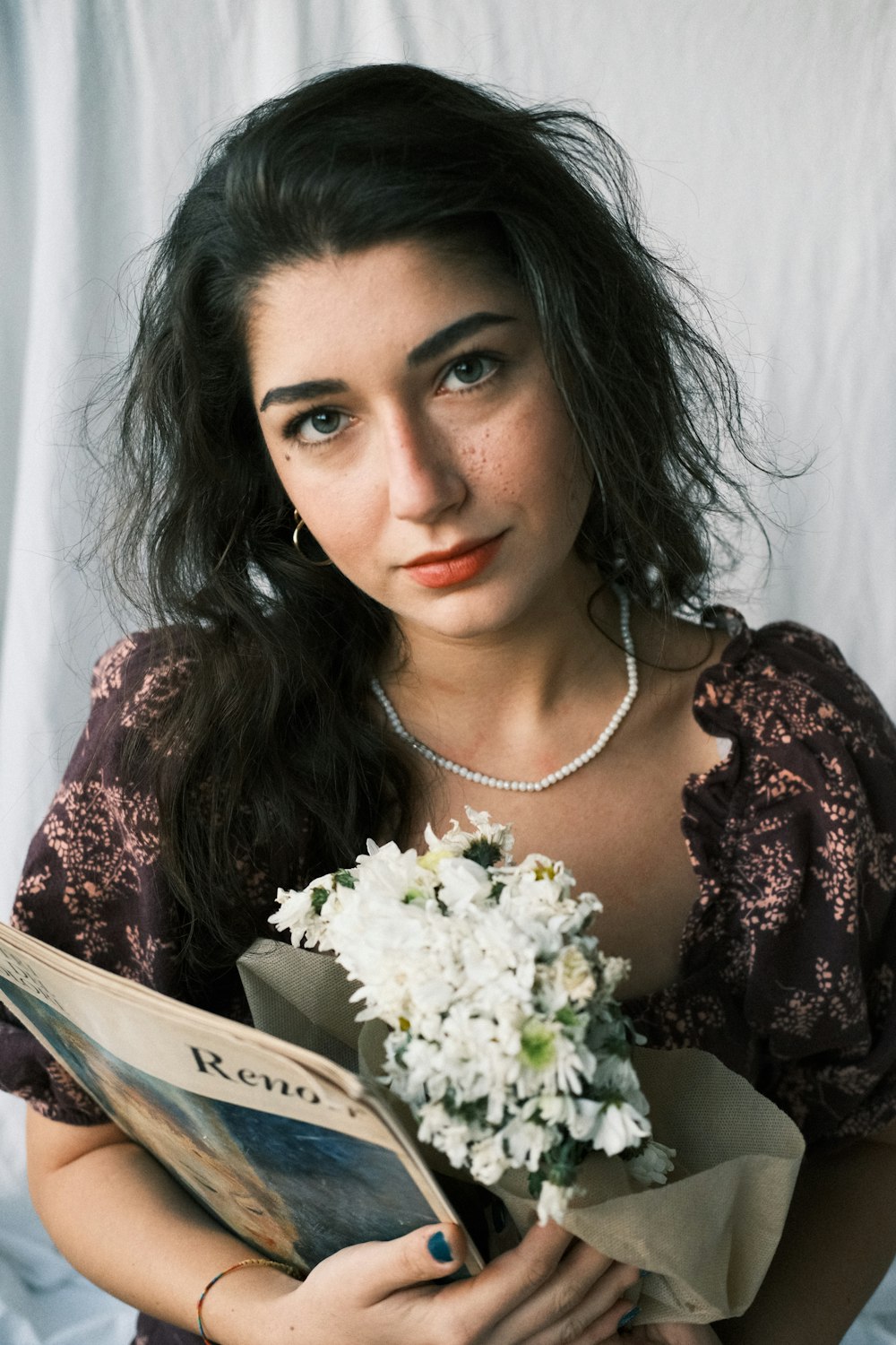 a woman is holding a bouquet of flowers