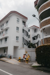 a couple of people sitting on a bench in front of a building