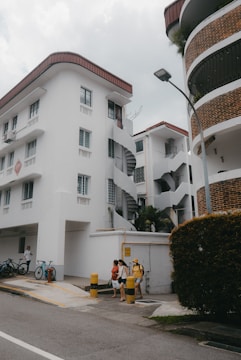 a couple of people sitting on a bench in front of a building