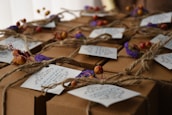 Gift boxes featuring bougi candles wrapped elegantly with natural twine.