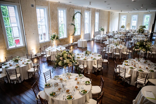 Elegant banquet hall set up for a wedding reception with warm lighting and floral decorations
