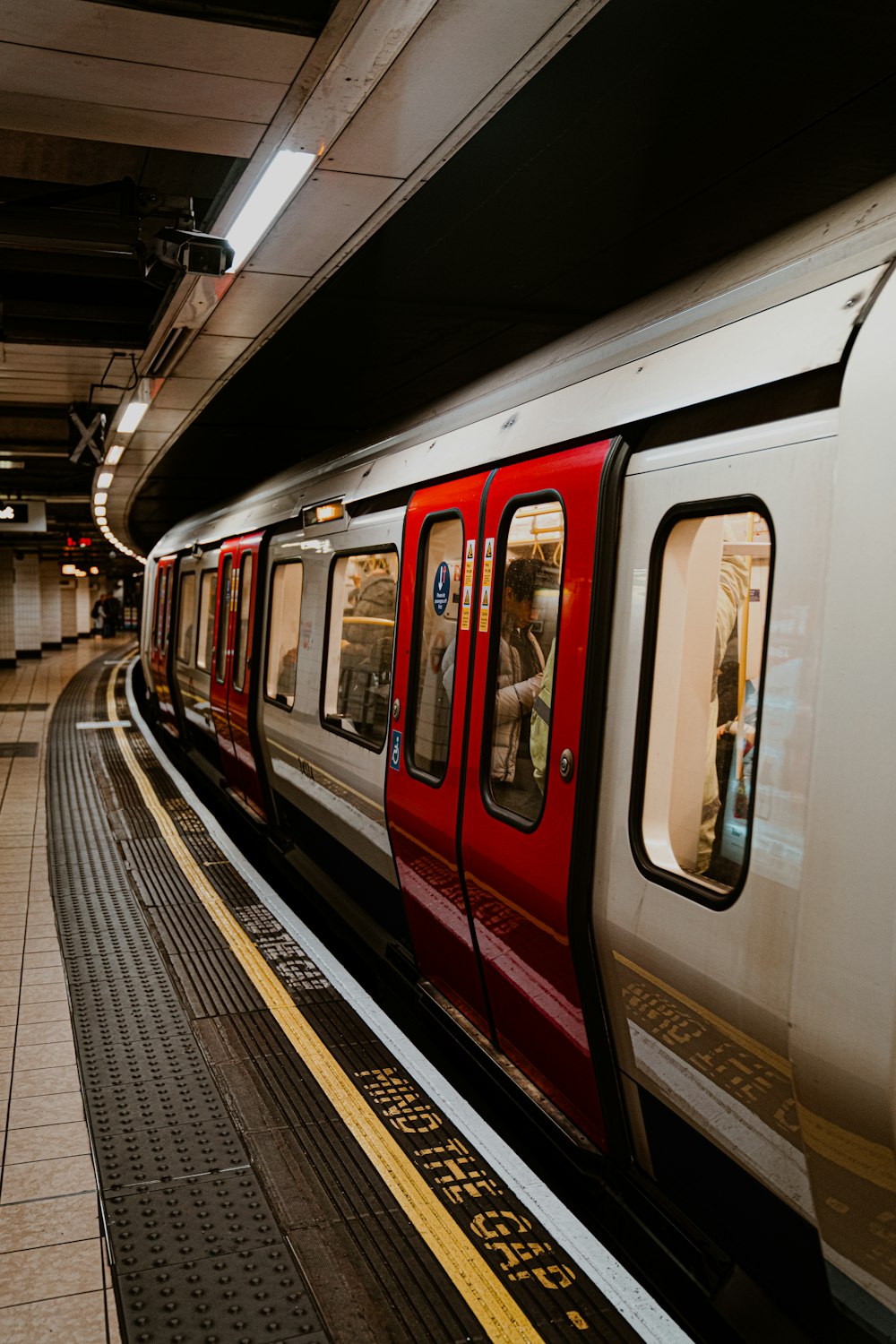 a red and white train traveling down train tracks