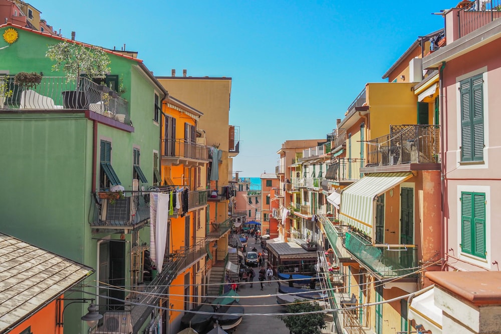 a narrow city street lined with colorful buildings