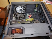 A happy customer unpacking their box of PC parts at home.