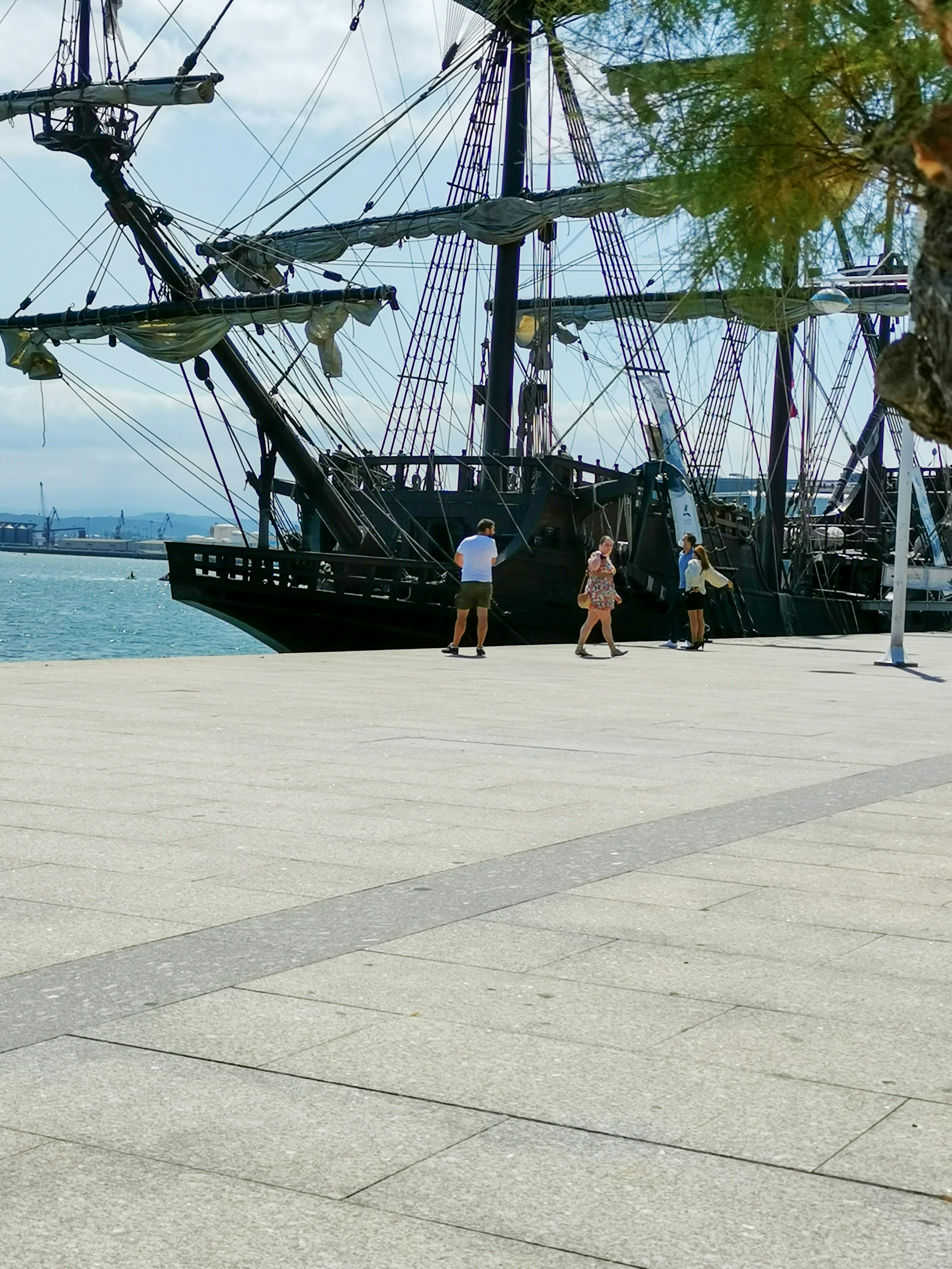 a group of people standing next to a large ship