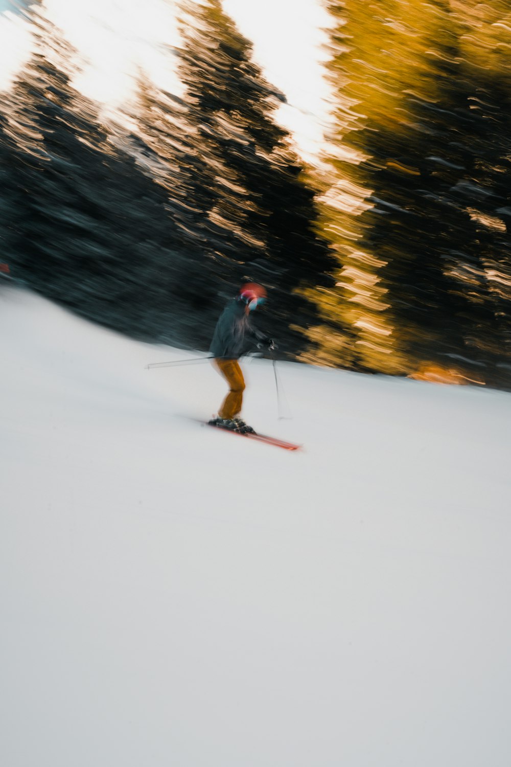 a man riding skis down a snow covered slope