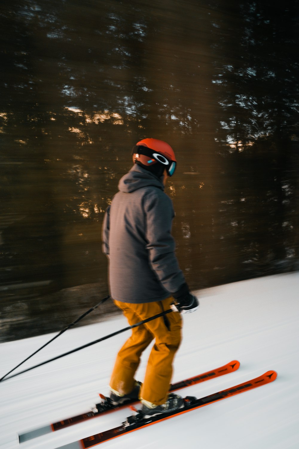 a man riding skis down a snow covered slope