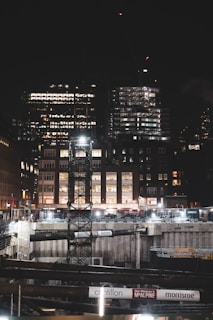 Night view of a well-lit construction site with ongoing work and safety measures in place.
