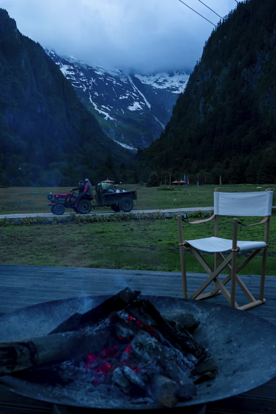 a chair sitting on top of a wooden deck next to a fire pit