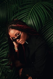 a woman with long braids and a black shirt