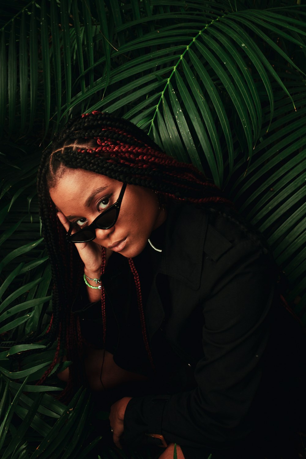 a woman with long braids and a black shirt