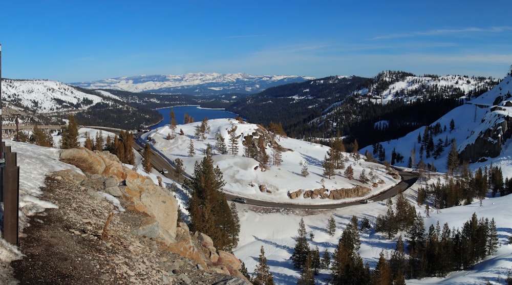 a view of a snowy mountain with a train on the tracks