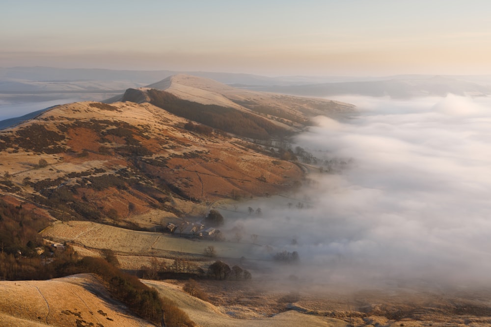 a view of a mountain covered in low lying clouds