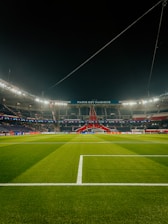 a soccer field at night with the lights on