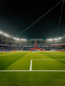 a soccer field at night with the lights on