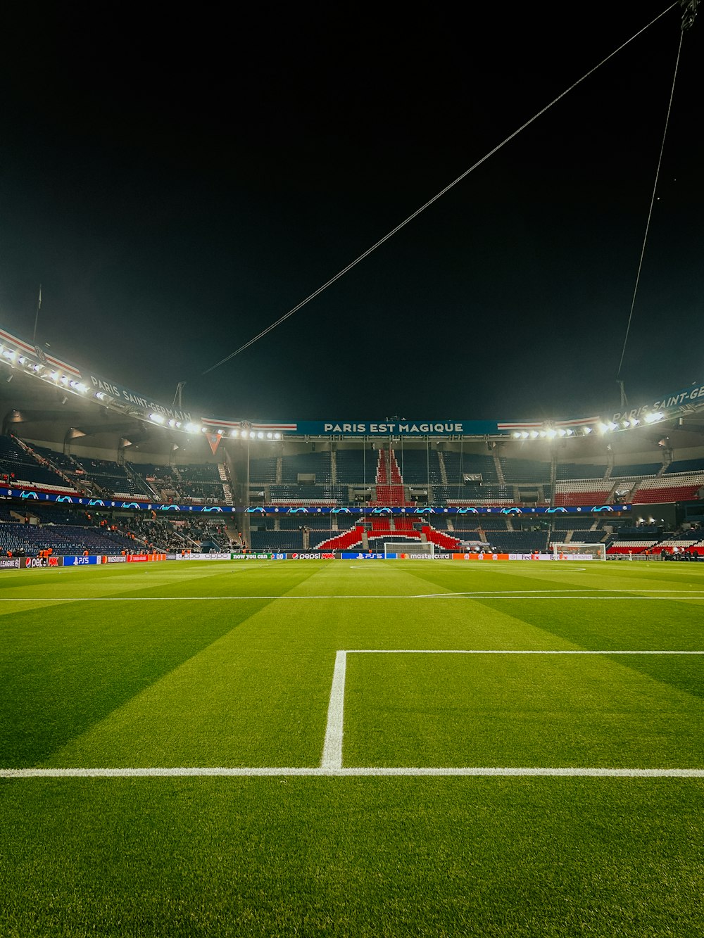 a soccer field at night with the lights on