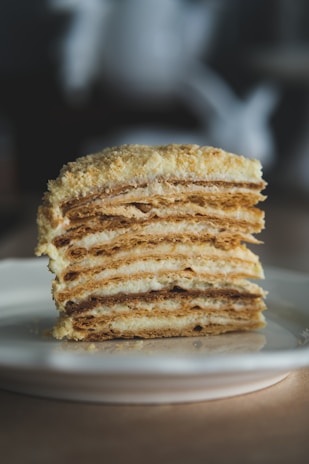 A close-up of a slice of cake showing its rich layers and frosting.
