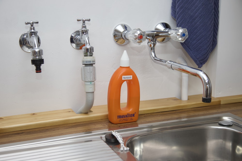 a kitchen sink with a sprayer and a sink faucet