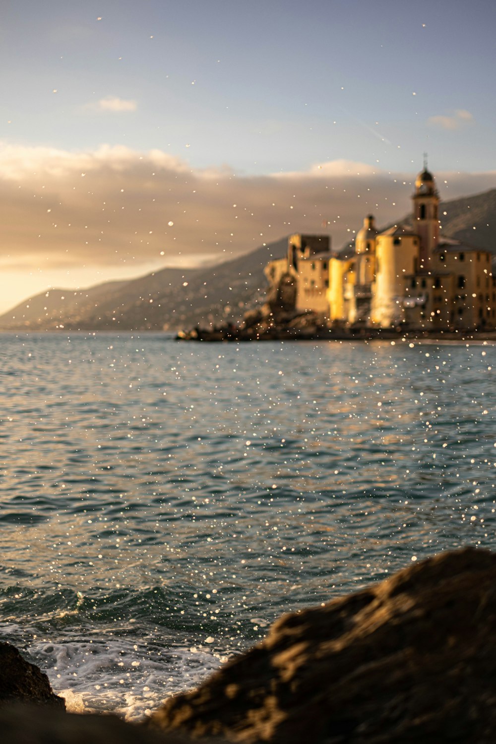 a view of a body of water with a castle in the background