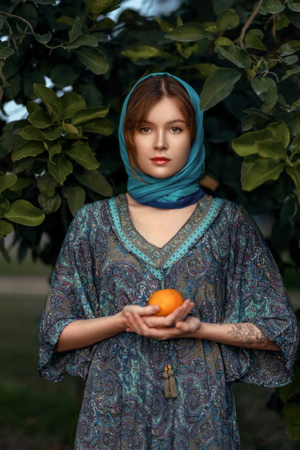 a woman holding an orange in her hands