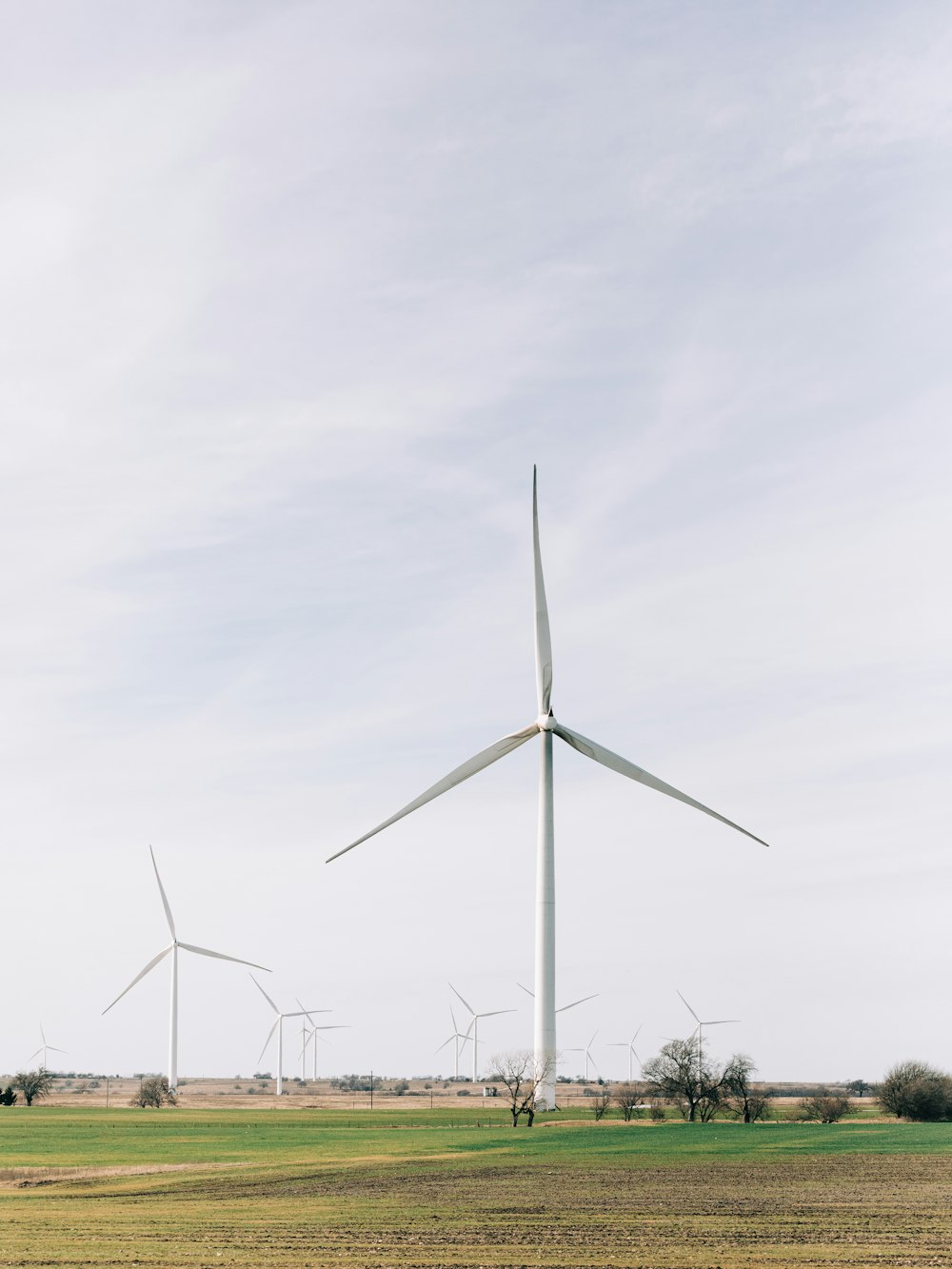 a wind farm with several windmills in the distance