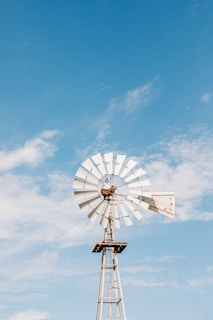 a windmill with a blue sky in the background