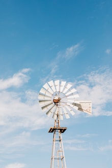 a windmill with a blue sky in the background