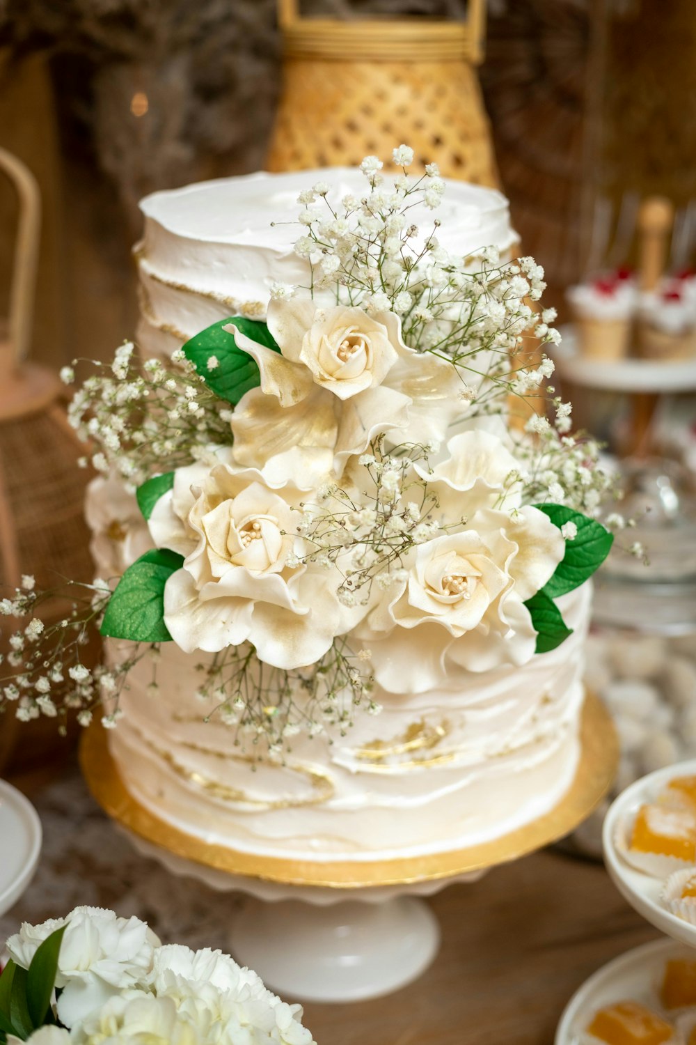 a wedding cake with white flowers on a table