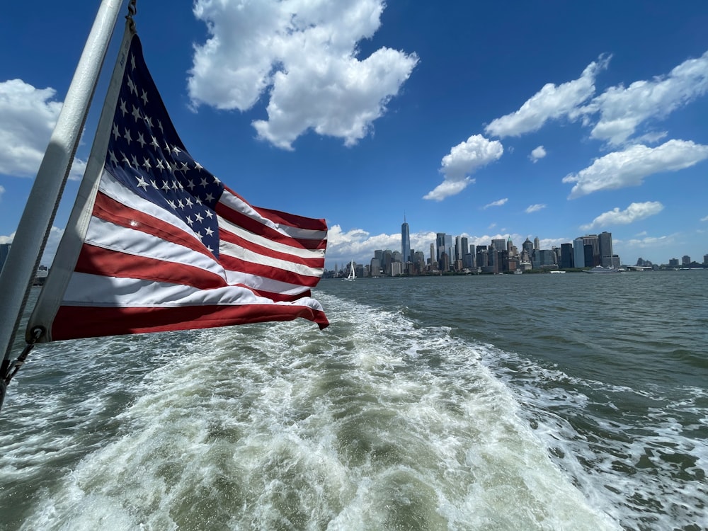 a large american flag on a boat in the water