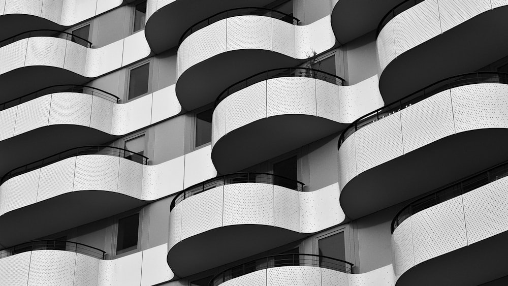 a black and white photo of a building with balconies