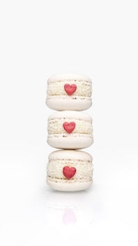 a stack of three macaroons with hearts on them