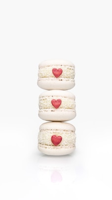 a stack of three macaroons with hearts on them