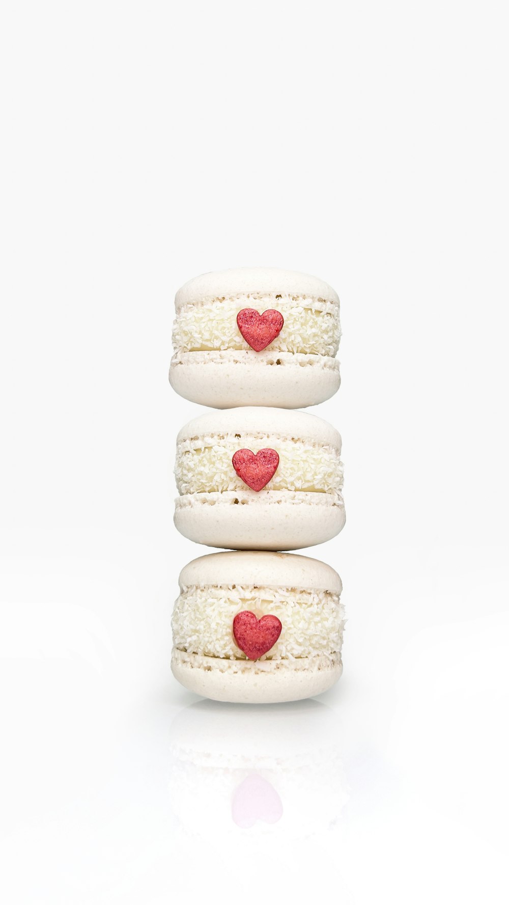 a stack of three macaroons with hearts on them
