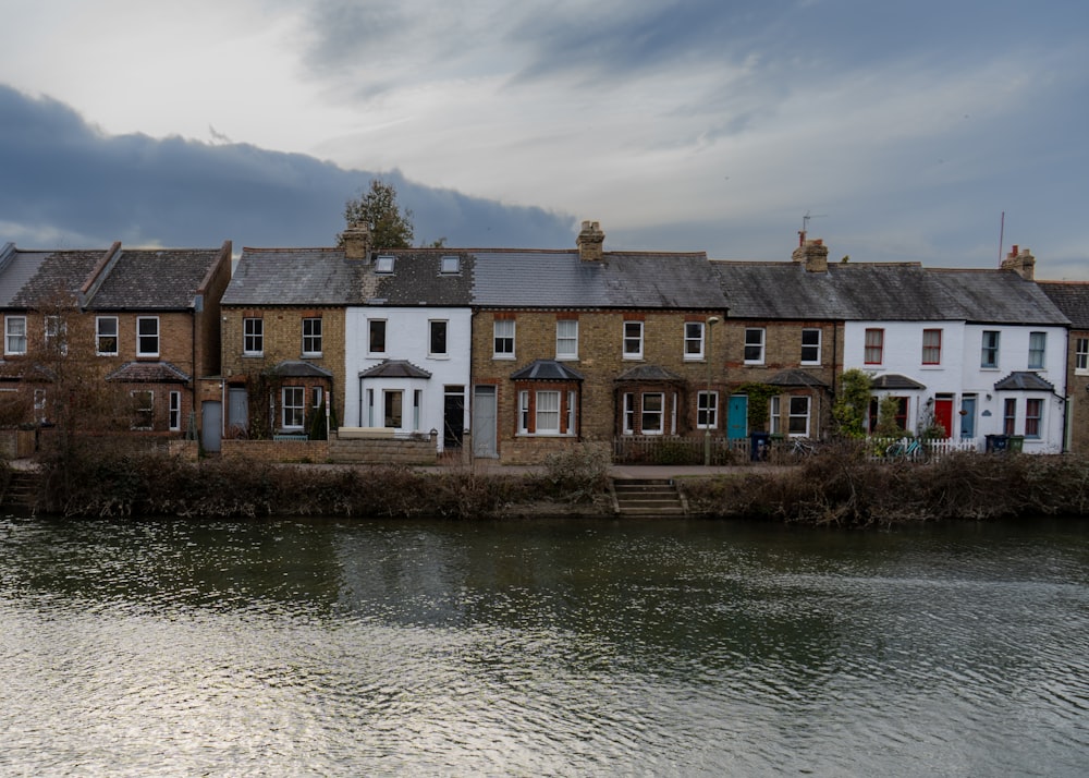 a row of houses next to a body of water