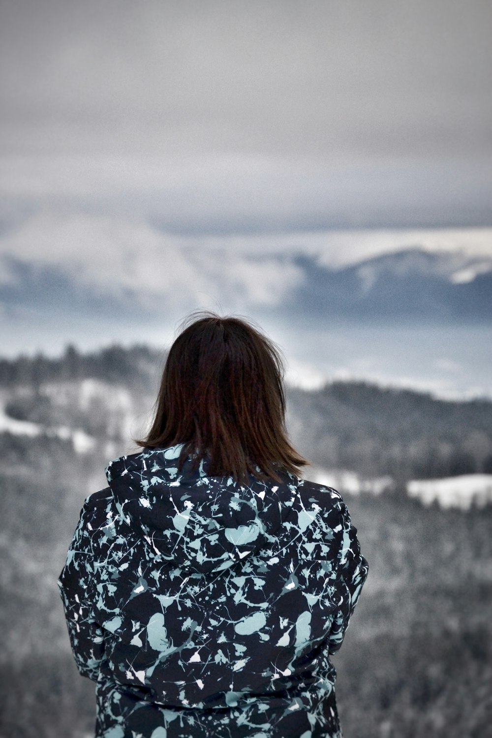 a woman standing on top of a snow covered slope