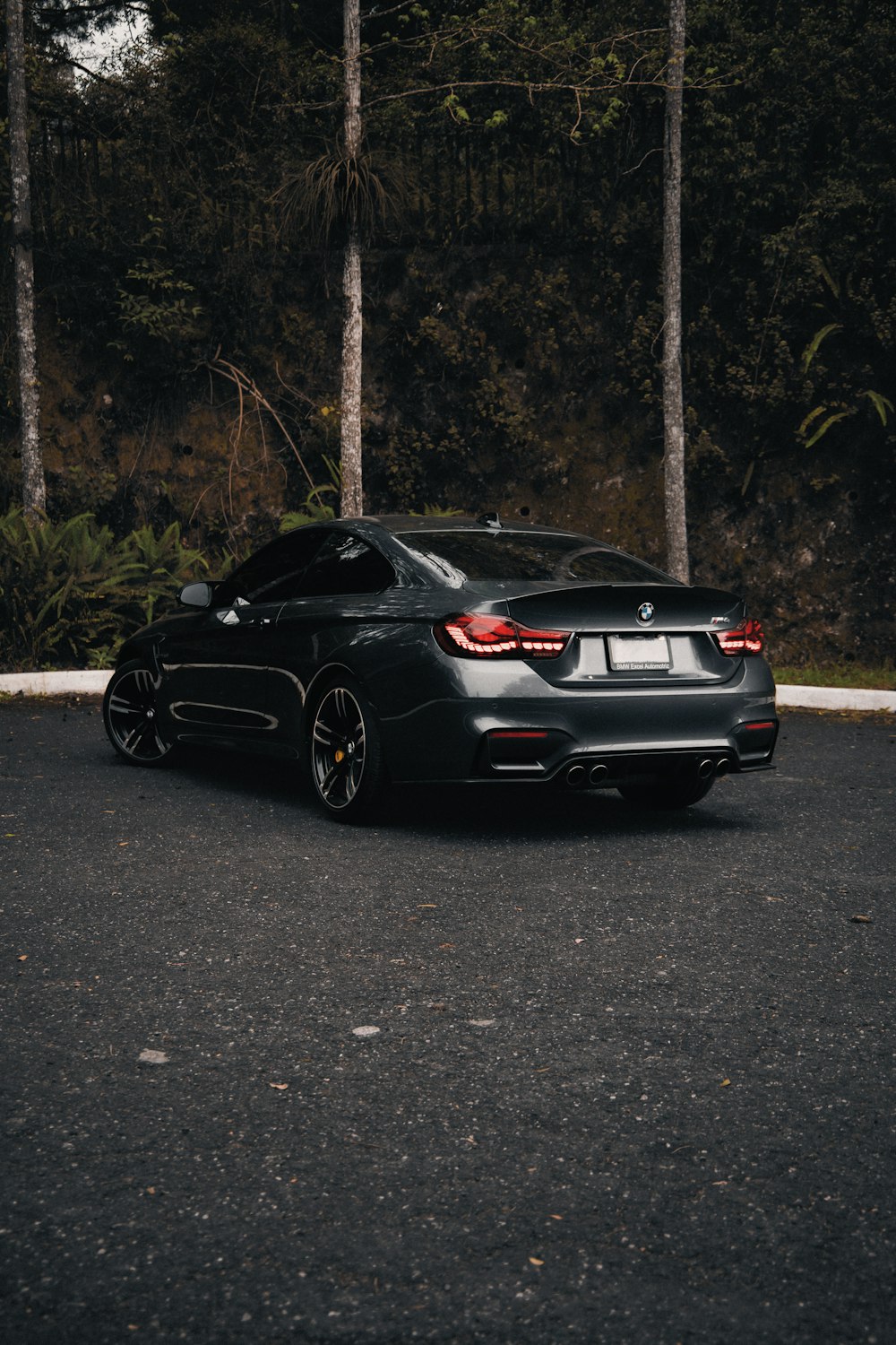 a black sports car parked in a parking lot