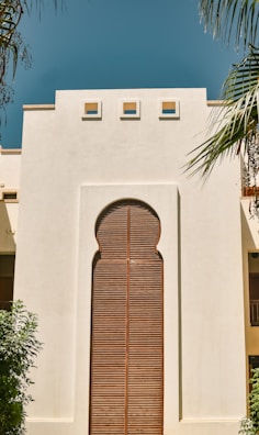 a large white building with a wooden door