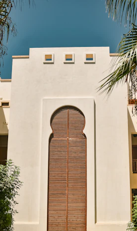 Stylish aluminum door set against a contemporary building facade in India.
