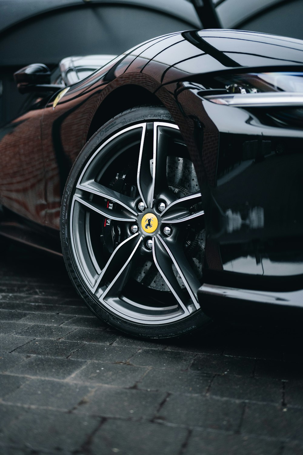 a black sports car parked in a parking lot