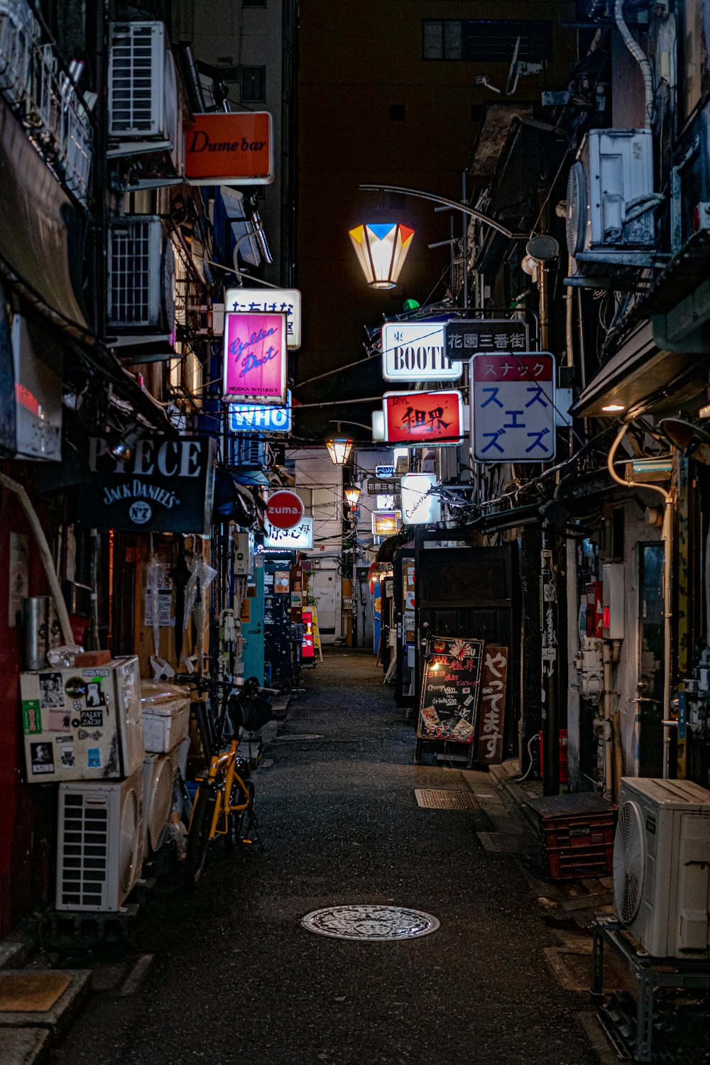 a narrow alley way with a lot of signs on it