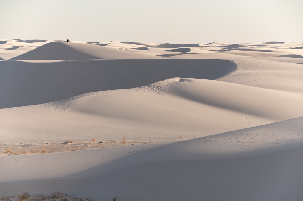 a person standing on top of a snow covered hill