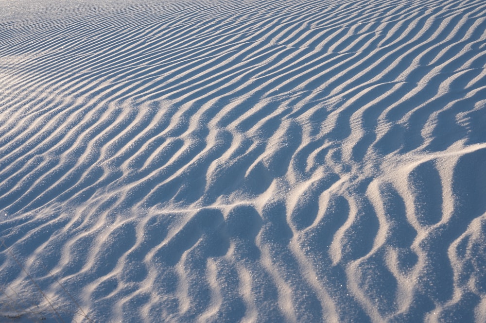 a large expanse of snow covered ground with a sky background