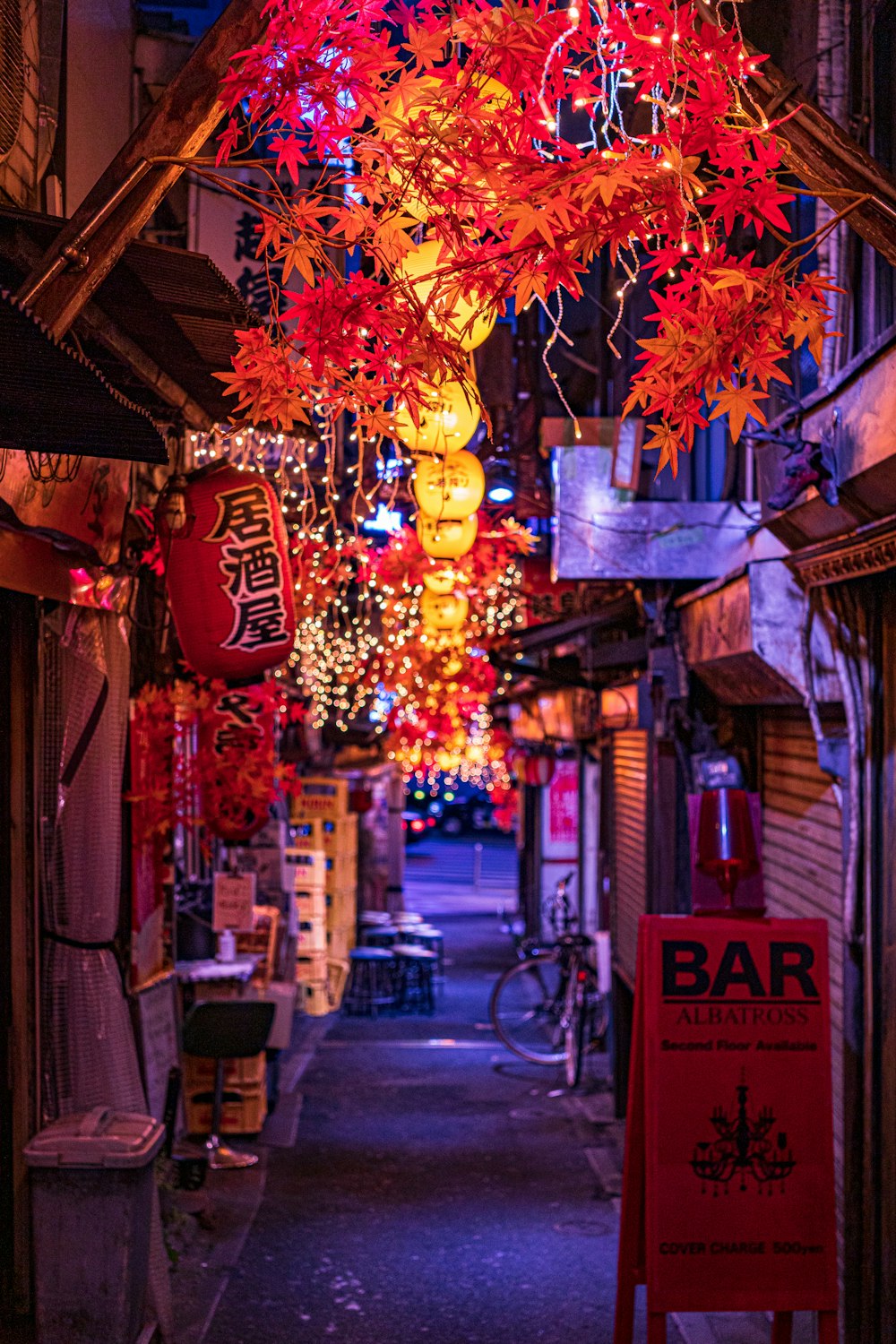 a street with a bunch of lights hanging from it's ceiling
