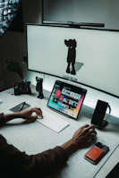 Minimalist workspace featuring Akira's software on multiple devices