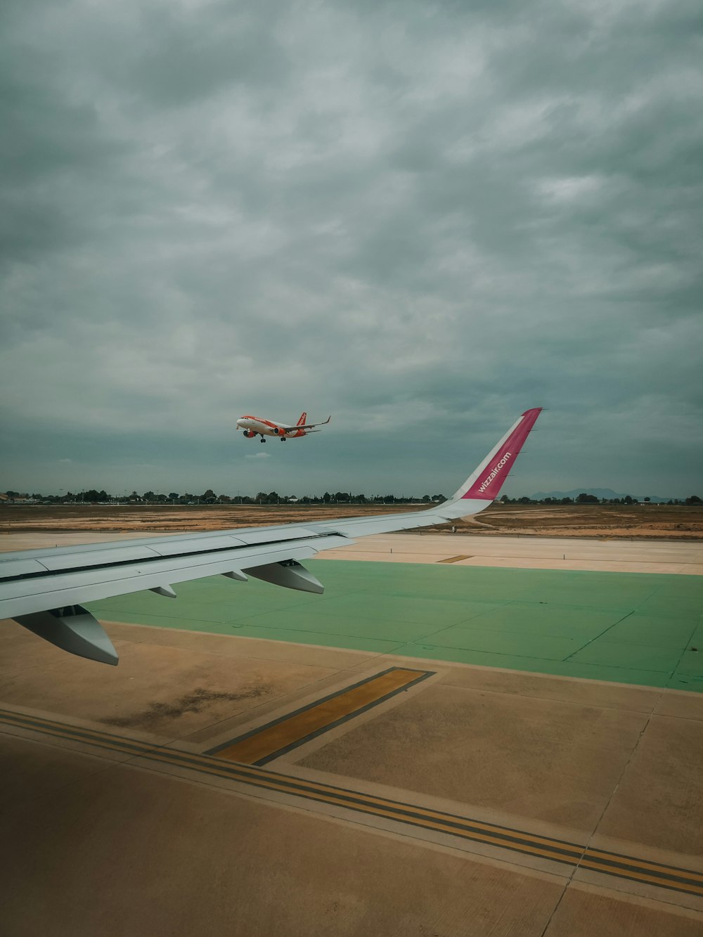 a large jetliner flying through a cloudy sky