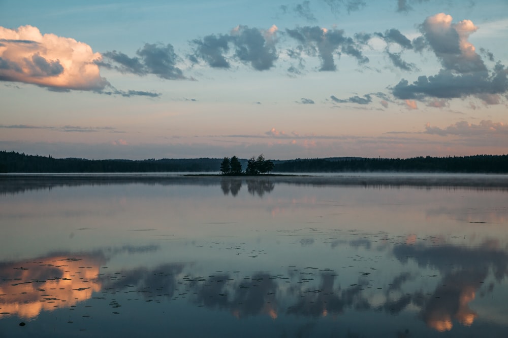 a large body of water with clouds in the sky