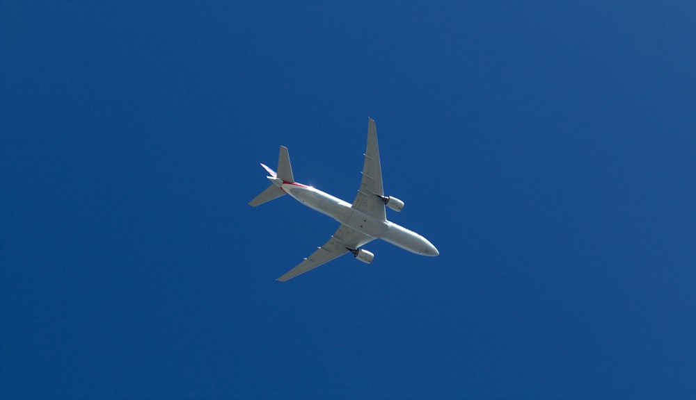 an airplane is flying in a clear blue sky