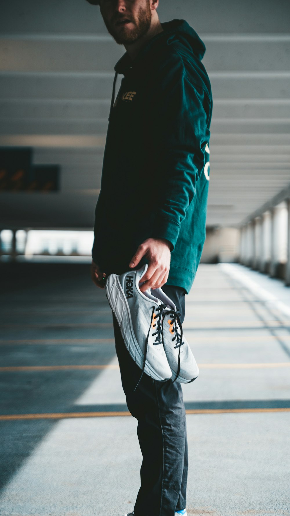 a man standing on a skateboard in a parking garage