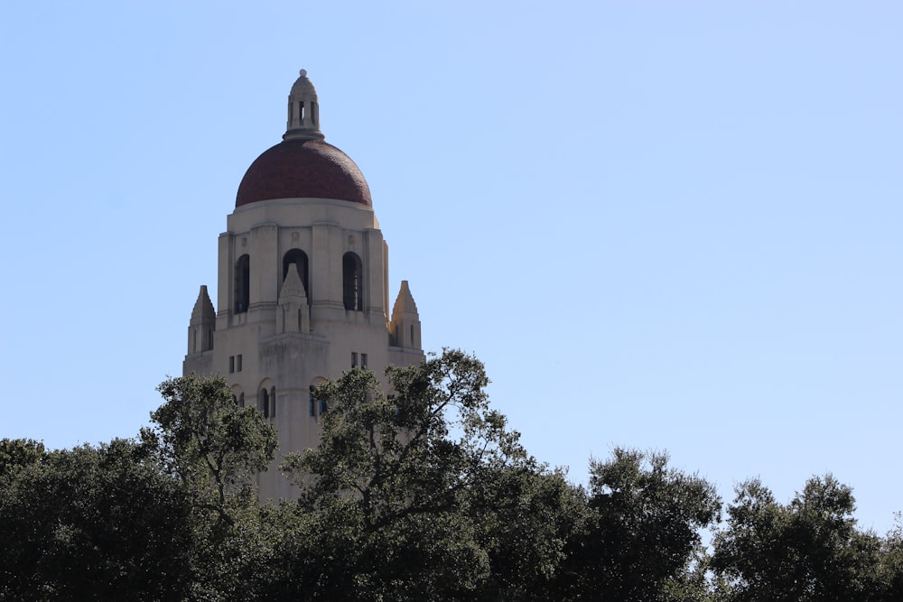 a tall building with a dome and a clock on top